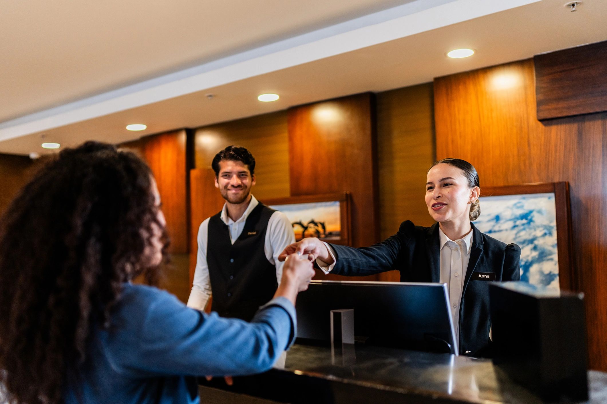 Hotel guest service interaction at a luxury reception desk