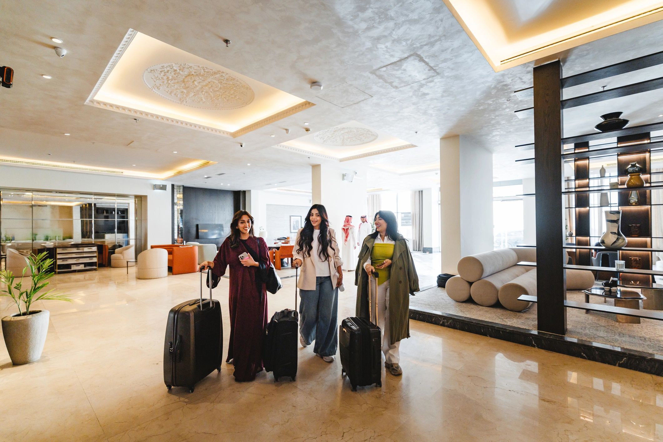 Guests arriving at a modern hotel lobby